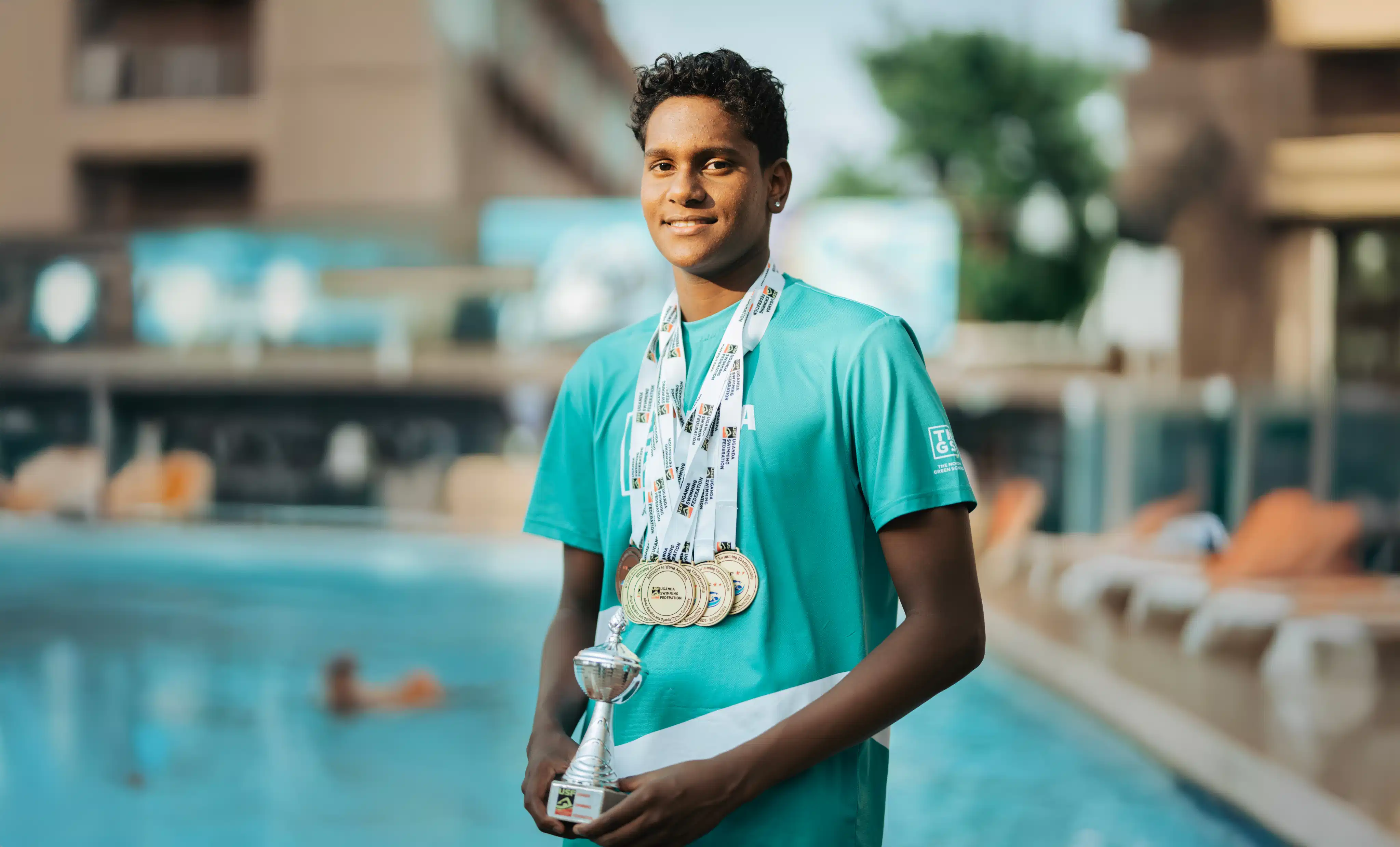 Boy holding swimming trophy